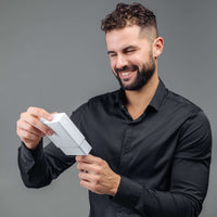 Thumbnail for Man smiling while opening a gift box containing the Minimalist Photo Bracelet by Brother & Sisters.