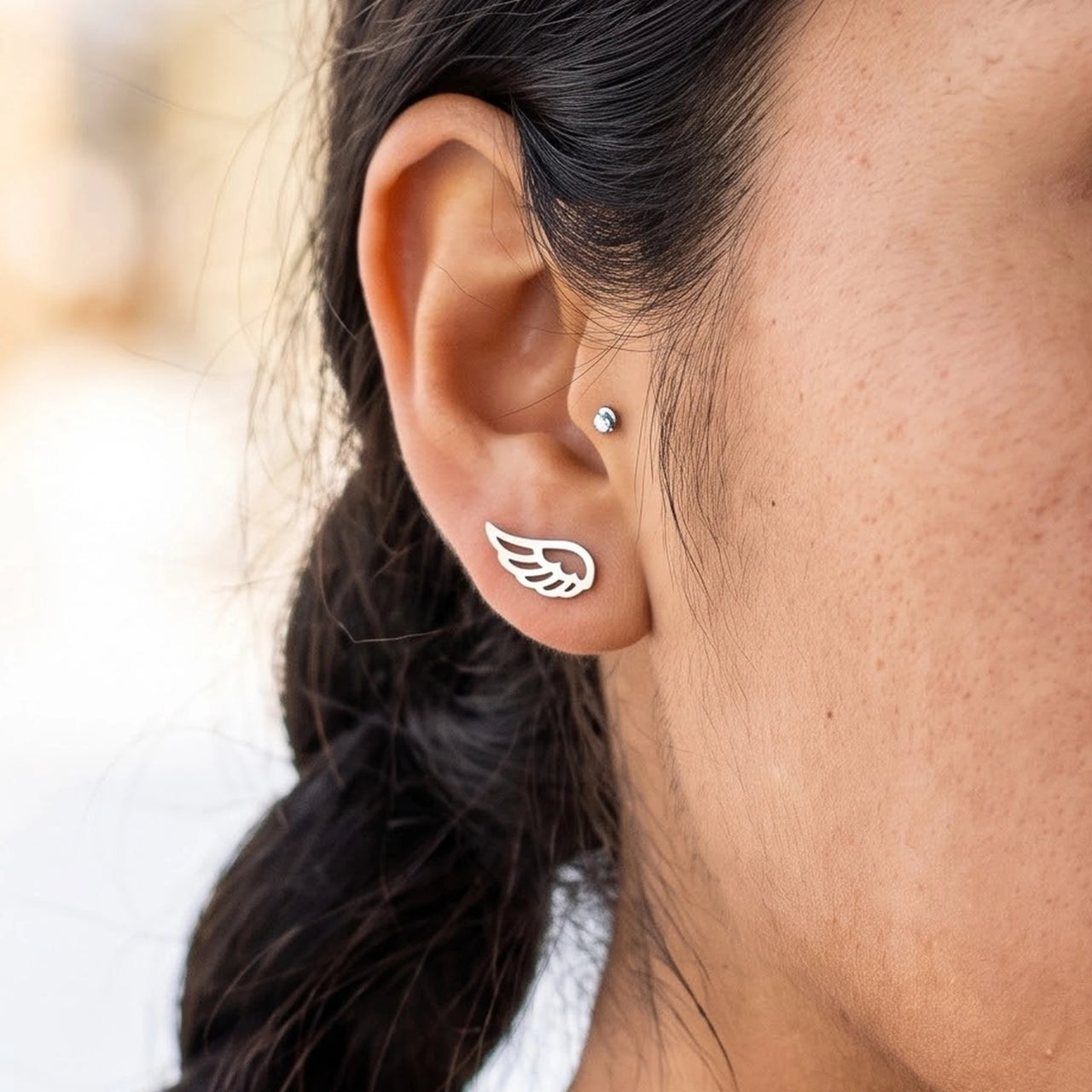 The silver stud earrings worn, close-up | SKU: 42008-silver