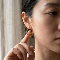 Thumbnail for Custom Name Hoop Earrings in Gold held between the fingertips, scale reference | SKU: name-hoop-gold-30-mm