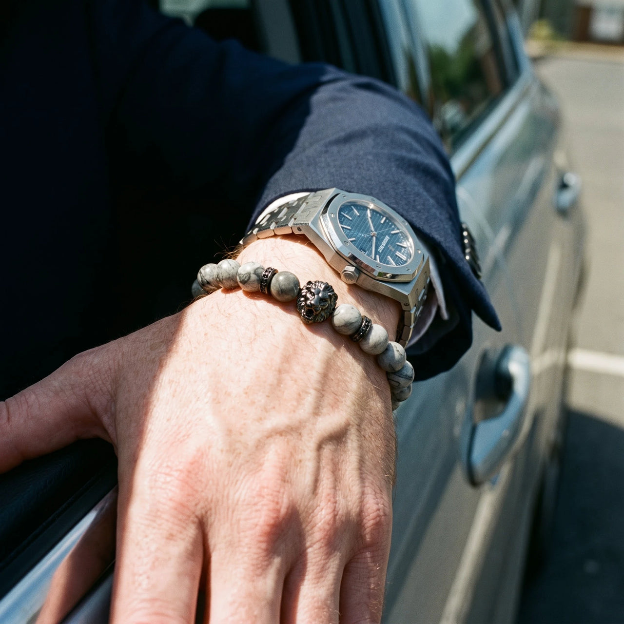 Black Lion & Grey Stones Bracelet – worn next to a luxury watch | Brother & Sisters | SKU: 20866222-gun-black-XS-14-15, 20866222-gun-black-S-16-17, 20866222-gun-black-M-18-19, 20866222-gun-black-L-20-21, 20866222-gun-black-XL-22-23