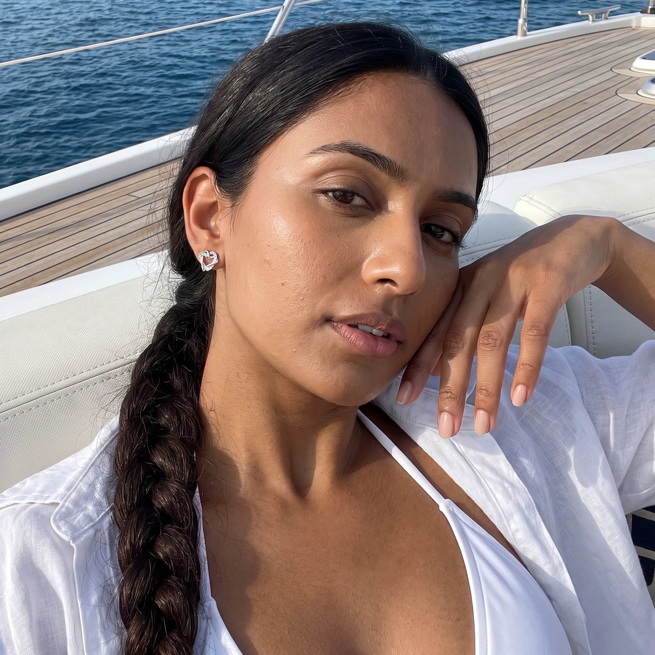 Woman on a yacht wearing the silver stud earrings | SKU: 4478648-platinum-plated-clear