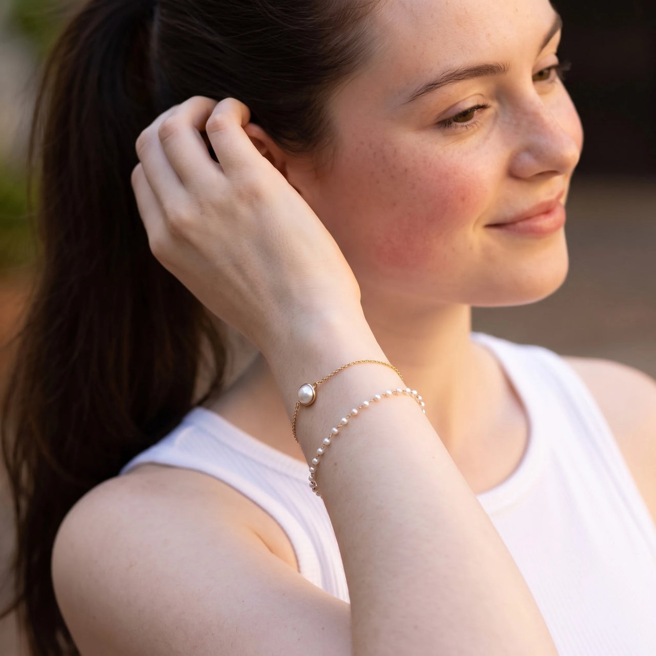 Pearl bracelet — worn, everyday gesture, gold | SKU: l-epure