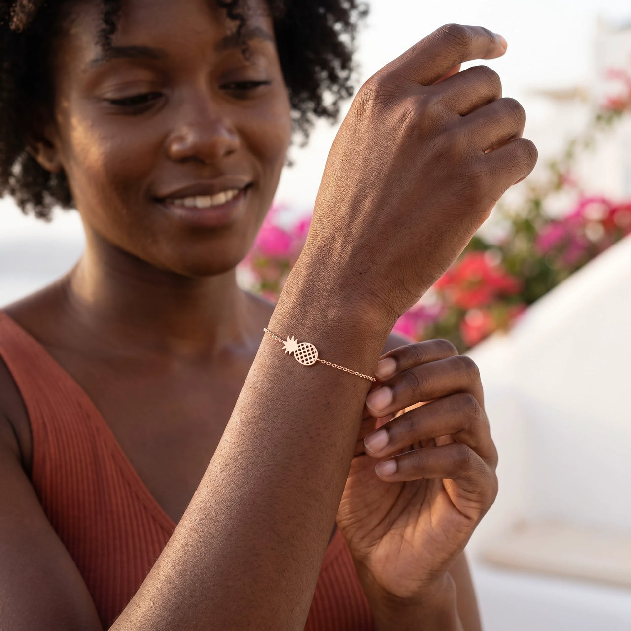 Woman gently touching her rose gold charm bracelet | SKU: 9178613-rose-gold