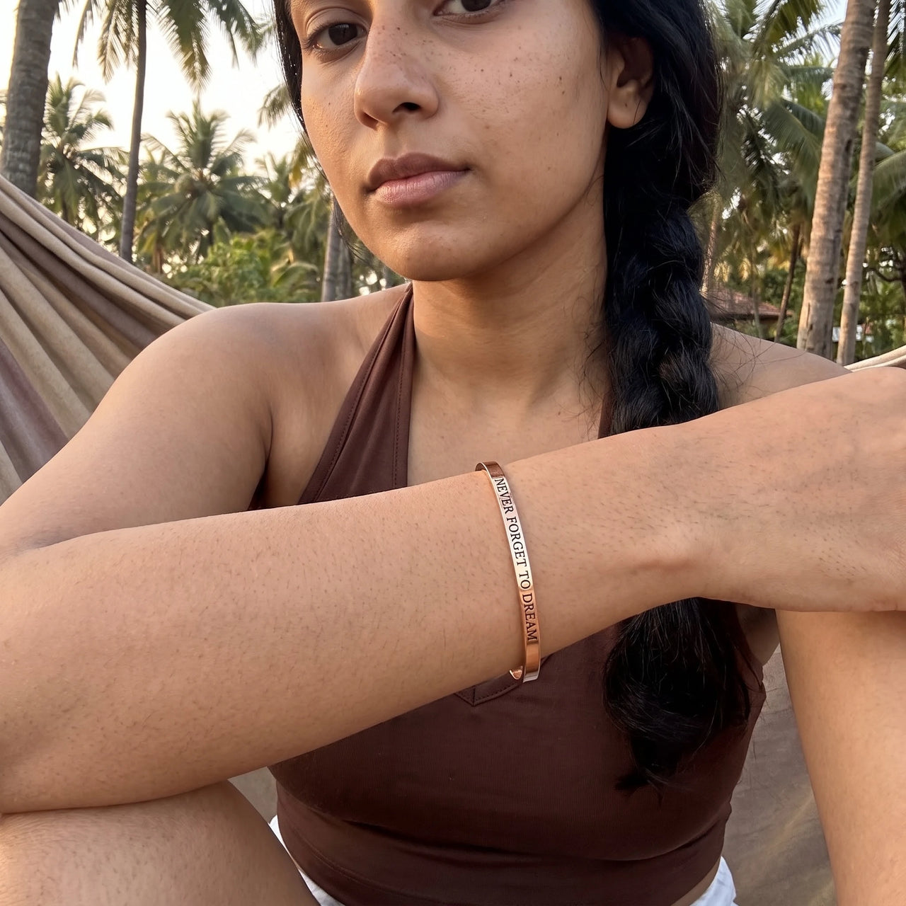 Never Forget To Dream bracelet in rose gold worn during a relaxed moment | SKU: nftd-rg