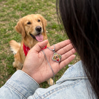 Thumbnail for Customer photo: the silver clover photo necklace with her dog's photo, her golden retriever in the background | SKU: TPH-CLVN-SILVER