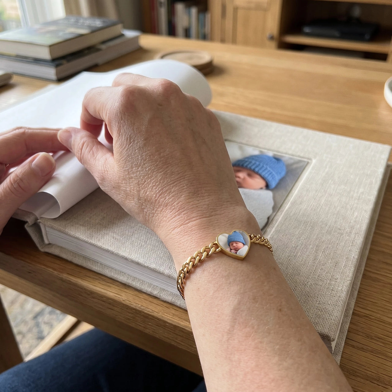 The gold heart photo bracelet on her wrist, showing its real small size | SKU: TPH-HRTB-GOLD