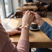 Thumbnail for Two friends holding hands over coffee, the rose gold octagon photo bracelet on her wrist | SKU: TPH-OCTB-ROSEGOLD-18